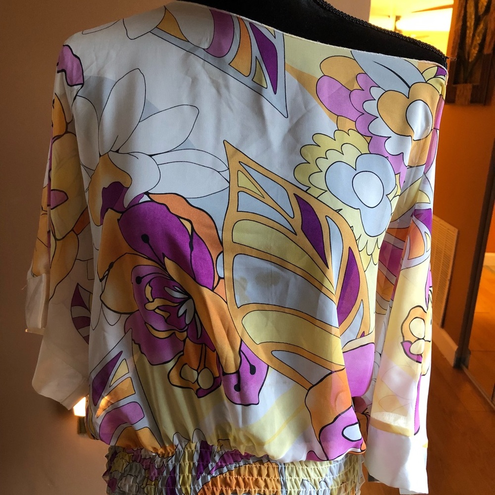 Multi colored off the shoulder shirt.